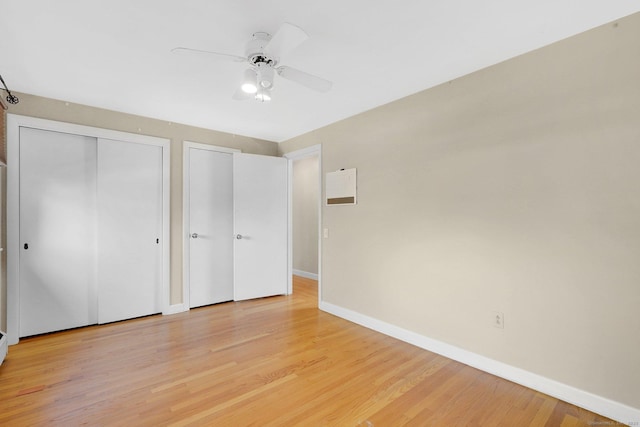 unfurnished bedroom with a closet, light wood-style flooring, a ceiling fan, and baseboards