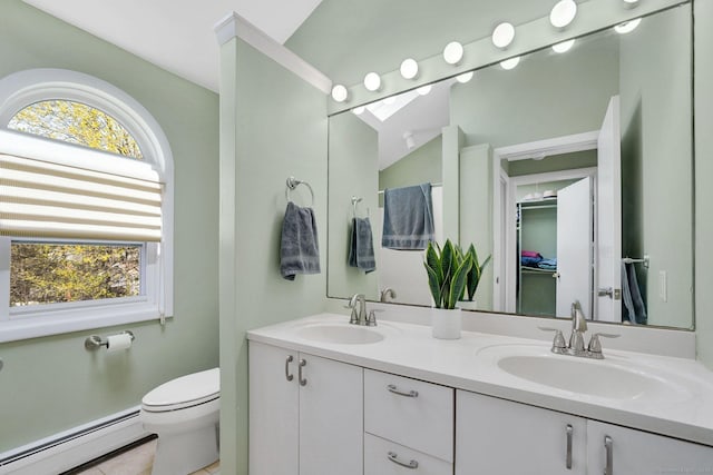 bathroom featuring toilet, a sink, tile patterned floors, and a baseboard radiator