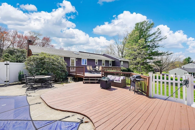 deck featuring an outdoor hangout area, area for grilling, a patio area, outdoor dining space, and fence