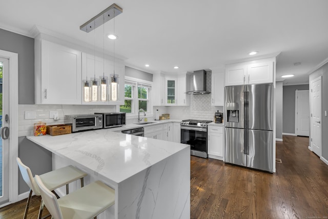 11 Botte Dr, West Haven, CT 06516 - kitchen with appliances with stainless steel finishes, wall chimney range hood, a sink, a peninsula, and crown molding