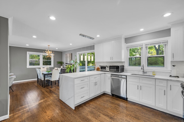 11 Botte Dr, West Haven, CT 06516 - kitchen featuring stainless steel appliances, a sink, a peninsula, crown molding, and plenty of natural light