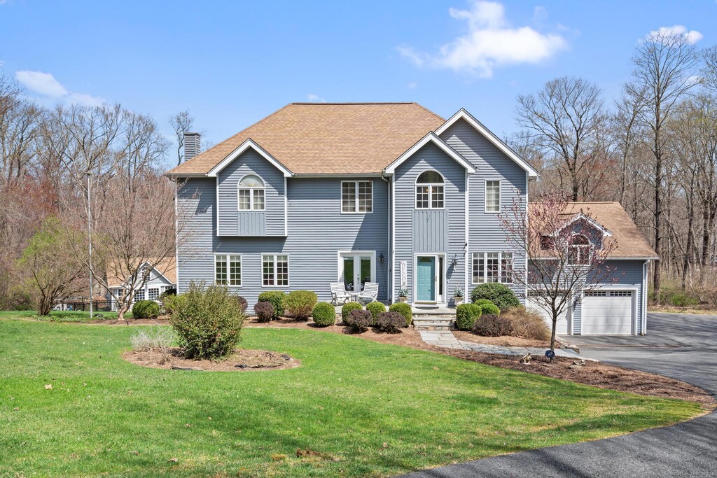 4 Possum Ln, New Milford, CT 06776 - view of front of home with a garage, a chimney, driveway, and a front lawn