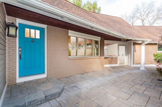 15 Fox Den Rd, Danbury, CT 06811 - property entrance featuring brick siding and roof with shingles