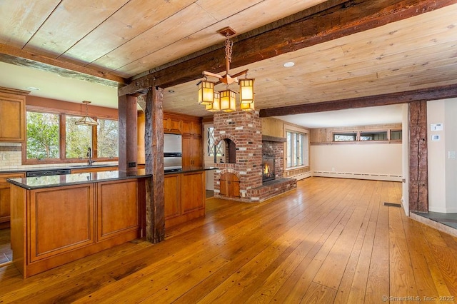 15 Fox Den Rd, Danbury, CT 06811 - unfurnished living room with hardwood / wood-style flooring, a baseboard radiator, a chandelier, and a sink