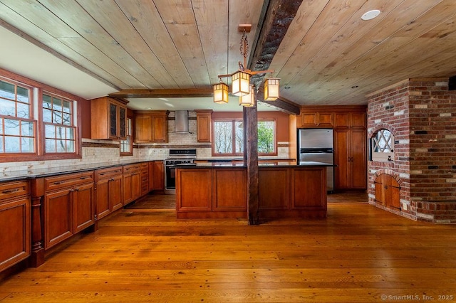 15 Fox Den Rd, Danbury, CT 06811 - kitchen with wall chimney exhaust hood, dark wood finished floors, freestanding refrigerator, gas range, and wood ceiling
