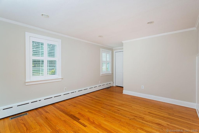 15 Fox Den Rd, Danbury, CT 06811 - unfurnished room featuring a baseboard heating unit, baseboards, ornamental molding, and light wood-type flooring