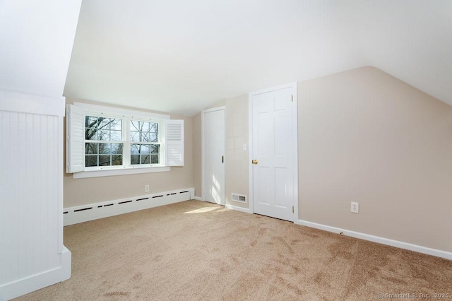 15 Fox Den Rd, Danbury, CT 06811 - additional living space featuring a baseboard radiator, vaulted ceiling, baseboards, and carpet