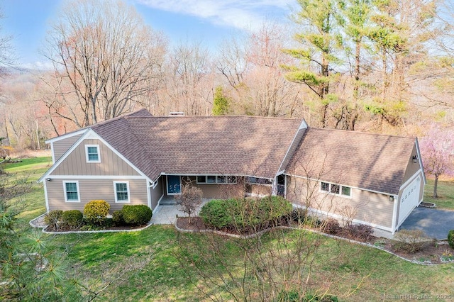 15 Fox Den Rd, Danbury, CT 06811 - view of front of house with an attached garage, a shingled roof, and a front lawn