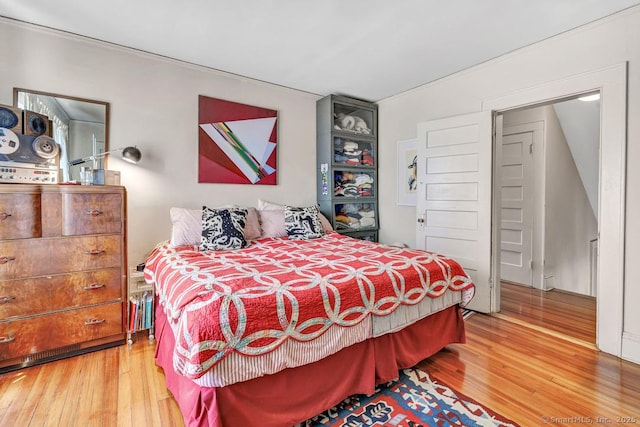 bedroom with hardwood / wood-style floors