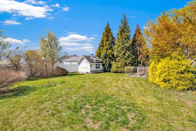 view of yard with an outbuilding and fence
