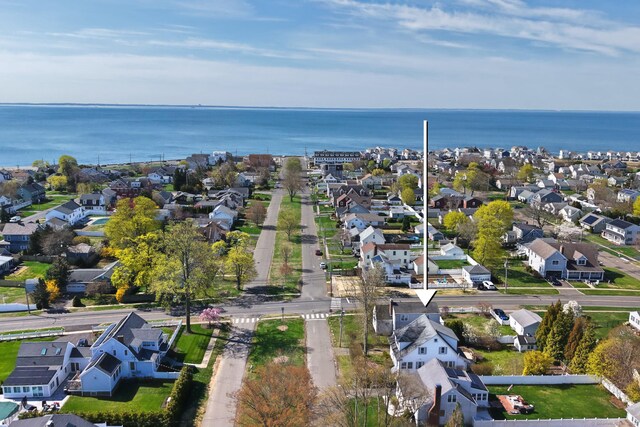 birds eye view of property featuring a water view and a residential view