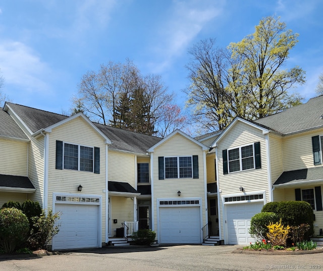 townhome / multi-family property featuring a garage