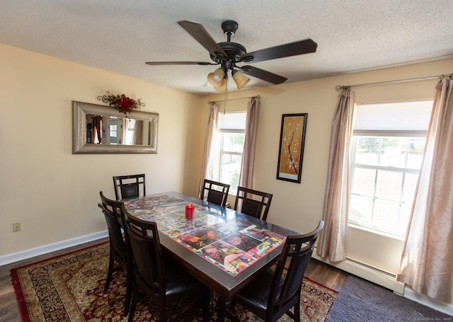 13 Damato Dr, Stonington, CT 06378 - dining space featuring wood finished floors, a baseboard radiator, baseboards, a ceiling fan, and a textured ceiling