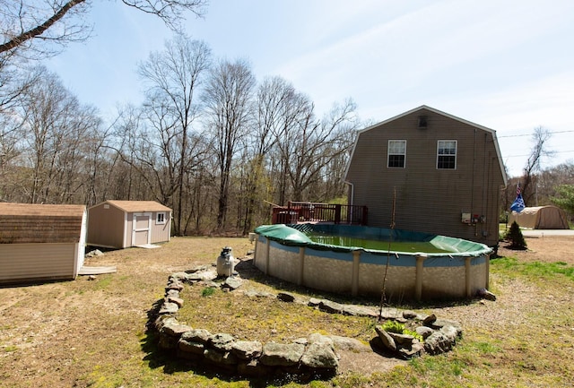 13 Damato Dr, Stonington, CT 06378 - view of yard with a covered pool, a wooden deck, an outbuilding, and a storage shed