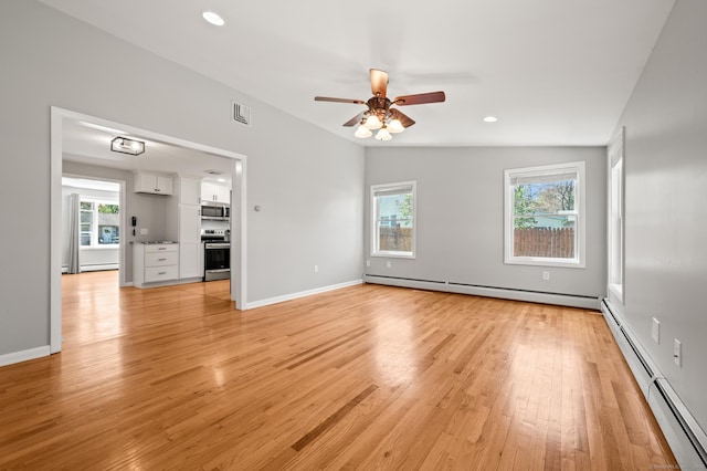 interior space featuring light wood-style floors, a baseboard radiator, a ceiling fan, and recessed lighting