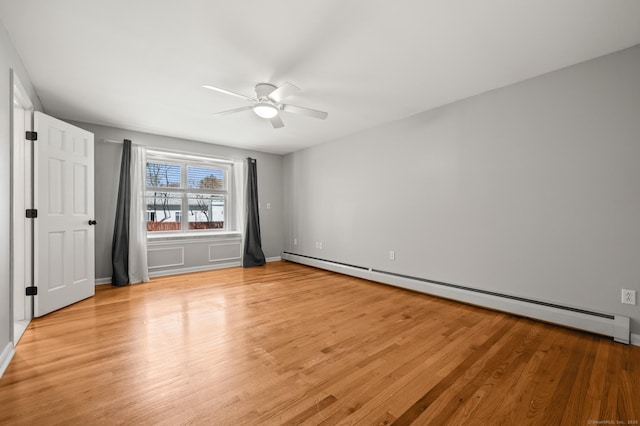 unfurnished bedroom with baseboards, ceiling fan, baseboard heating, and light wood-type flooring
