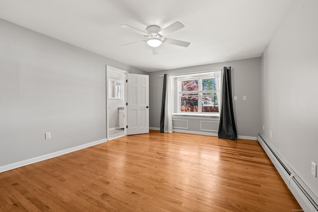 empty room with a ceiling fan, baseboards, baseboard heating, and light wood-style floors