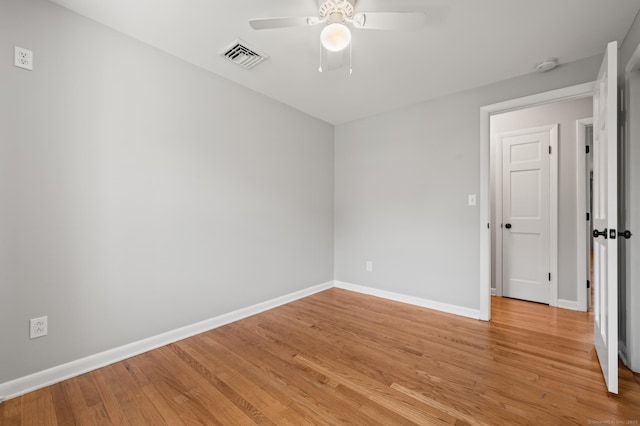 unfurnished room featuring a ceiling fan, baseboards, visible vents, and light wood finished floors