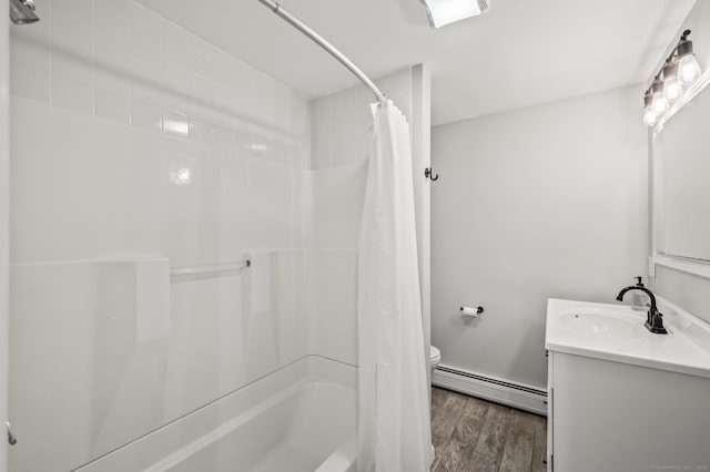 full bathroom featuring vanity, wood finished floors, toilet, baseboard heating, and shower / bath combo