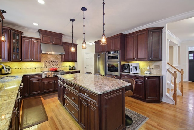 96 Damascus Rd, Branford, CT 06405 - kitchen with light wood finished floors, stainless steel appliances, a sink, decorative backsplash, and under cabinet range hood