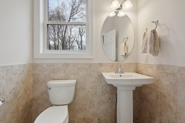96 Damascus Rd, Branford, CT 06405 - half bathroom with tile walls, a wainscoted wall, and toilet