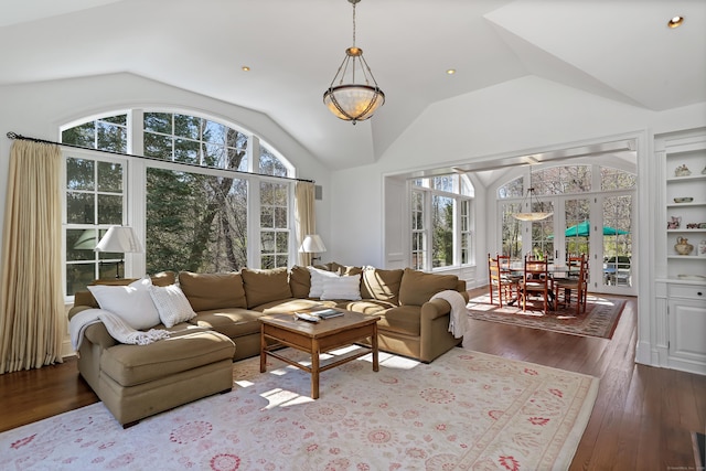 living room featuring dark wood-style flooring, lofted ceiling, and plenty of natural light