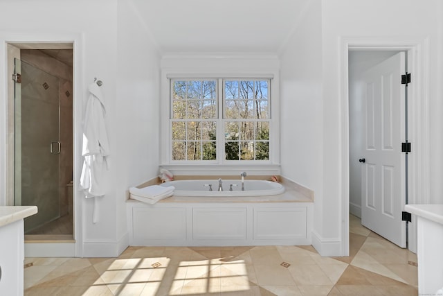 full bathroom with tile patterned floors, a shower stall, ornamental molding, a bath, and baseboards