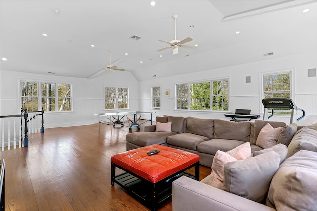 living room with a healthy amount of sunlight, a ceiling fan, visible vents, and vaulted ceiling