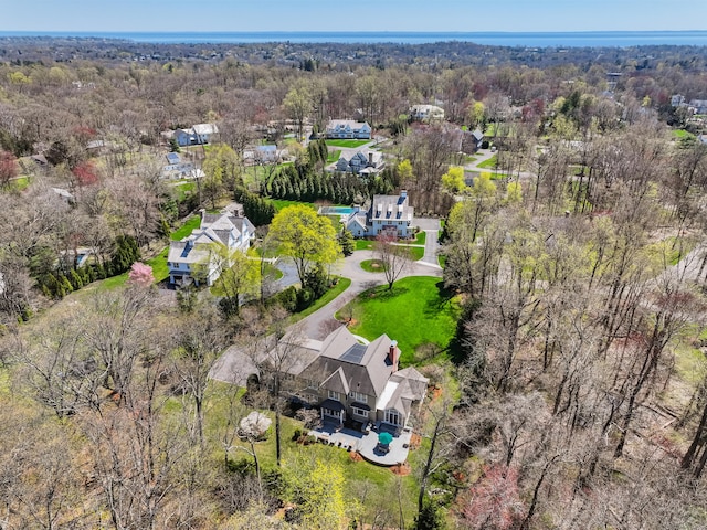 birds eye view of property featuring a wooded view and a residential view