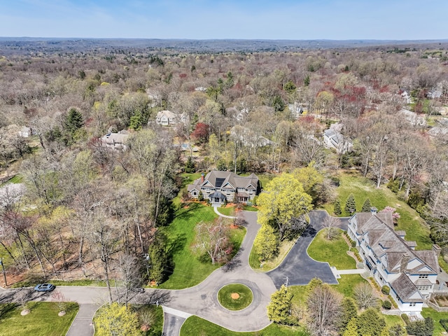 drone / aerial view featuring a wooded view