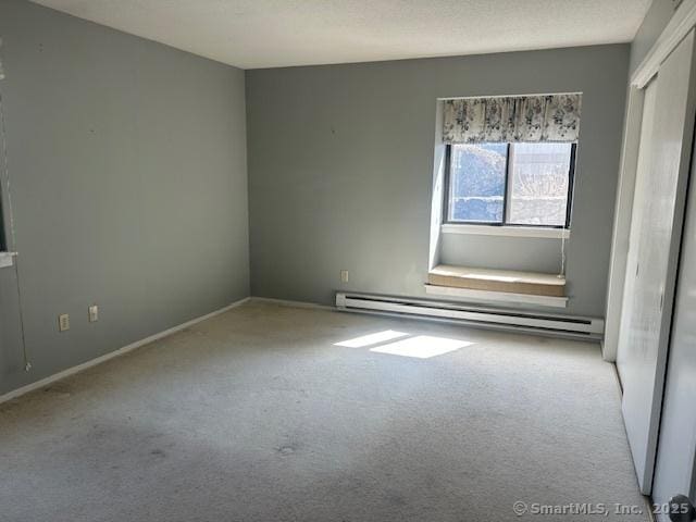 9 Heritage Cir Unit D, Southbury, CT 06488 - carpeted spare room featuring a baseboard heating unit and baseboards