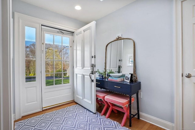 doorway featuring recessed lighting, light wood-style flooring, and baseboards