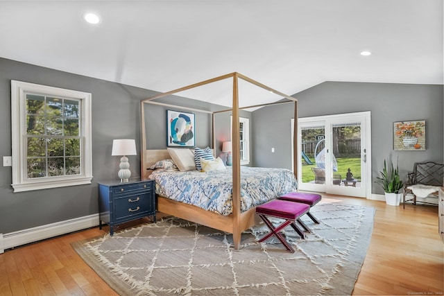 bedroom featuring lofted ceiling, a baseboard heating unit, access to exterior, baseboards, and wood finished floors