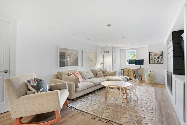 living room featuring visible vents, recessed lighting, and light wood-style flooring