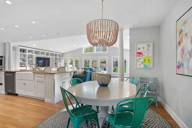 dining space with recessed lighting, a notable chandelier, light wood-style floors, and vaulted ceiling