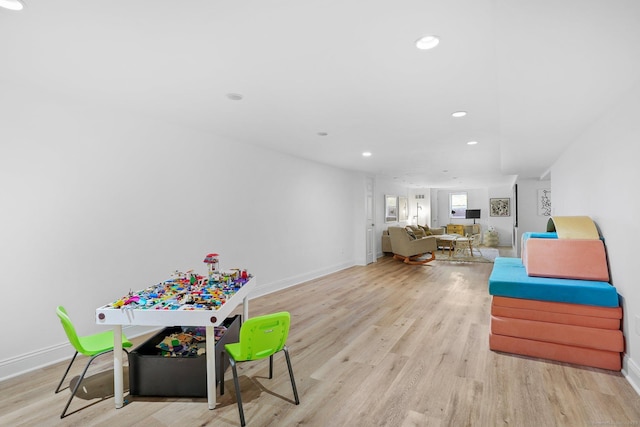recreation room with recessed lighting, wood finished floors, and baseboards