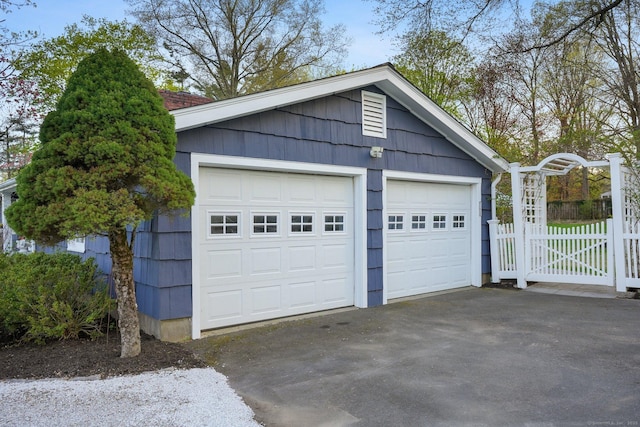 detached garage featuring fence