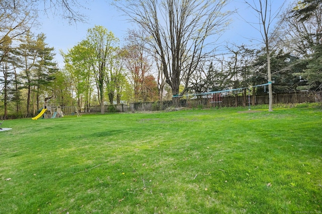view of yard featuring a playground and fence