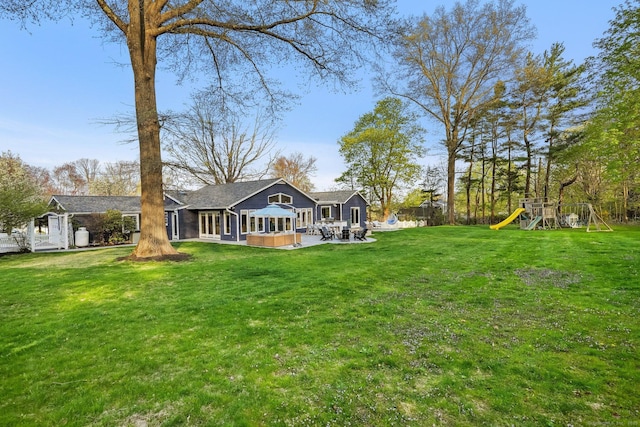 view of yard with a playground and a patio area