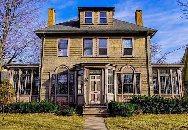 187 W Park Ave, New Haven, CT 06511 - view of front of property with a chimney, a front lawn, a sunroom, and roof with shingles