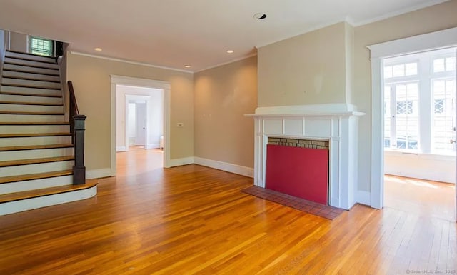 187 W Park Ave, New Haven, CT 06511 - unfurnished living room featuring light wood-style flooring, ornamental molding, baseboards, stairway, and a fireplace with flush hearth