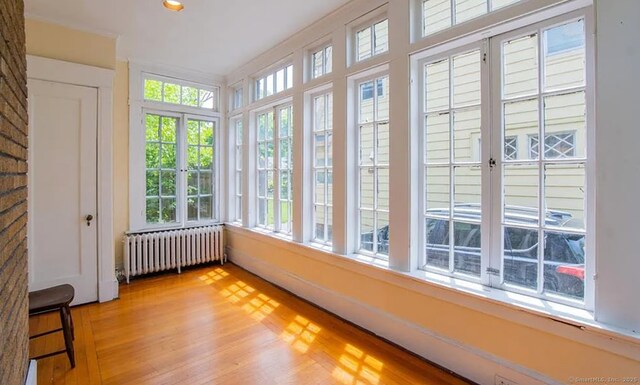 187 W Park Ave, New Haven, CT 06511 - unfurnished sunroom with radiator heating unit, wood finished floors, french doors, and recessed lighting