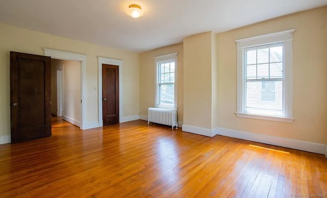 187 W Park Ave, New Haven, CT 06511 - unfurnished room featuring radiator heating unit, light wood-style flooring, and baseboards
