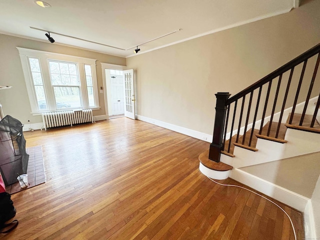 187 W Park Ave, New Haven, CT 06511 - unfurnished living room with hardwood / wood-style floors, baseboards, and radiator
