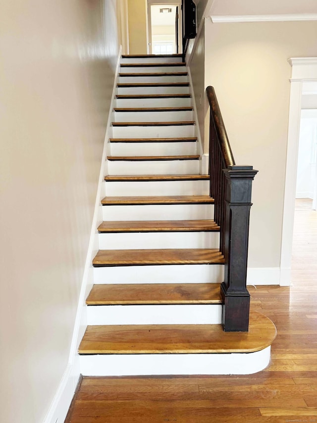 187 W Park Ave, New Haven, CT 06511 - stairway featuring baseboards, wood finished floors, and crown molding