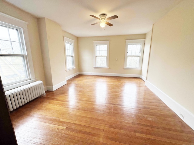 187 W Park Ave, New Haven, CT 06511 - spare room featuring ceiling fan, baseboards, light wood finished floors, and radiator