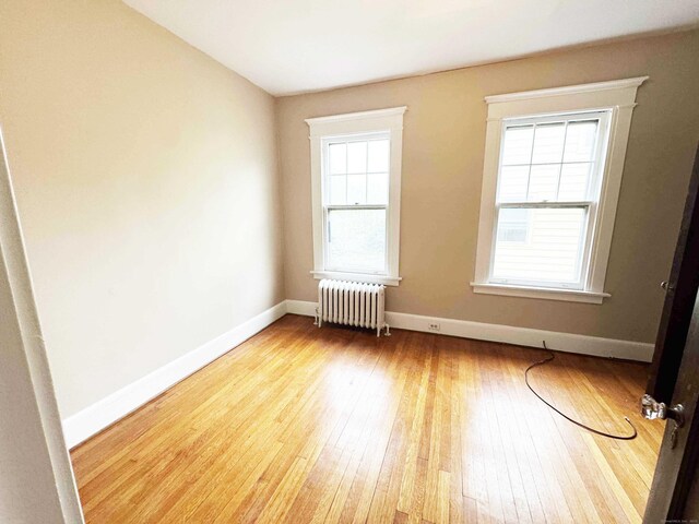 187 W Park Ave, New Haven, CT 06511 - empty room with baseboards, wood-type flooring, and radiator