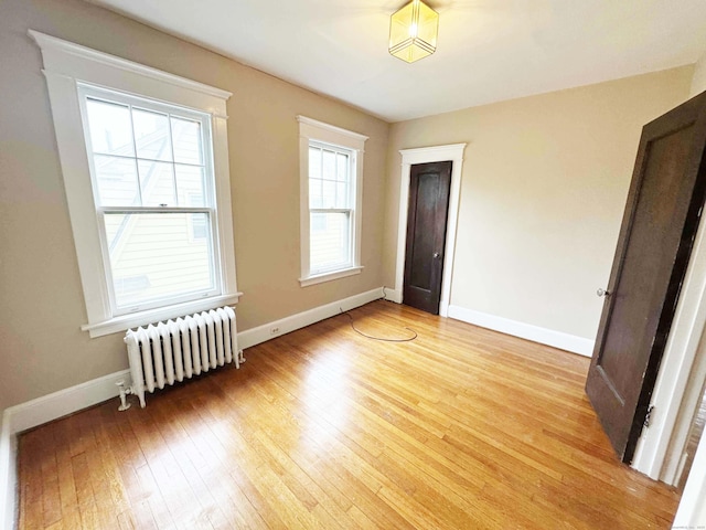 187 W Park Ave, New Haven, CT 06511 - empty room with radiator heating unit, light wood finished floors, and baseboards