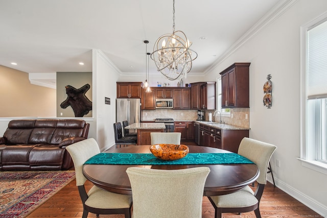 dining area featuring a notable chandelier, dark wood-type flooring, plenty of natural light, and recessed lighting