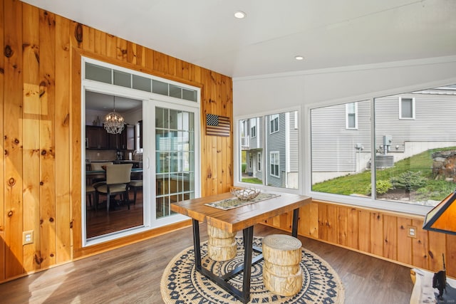 sunroom / solarium featuring a notable chandelier